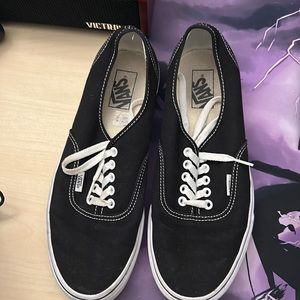 Black and white low top vans